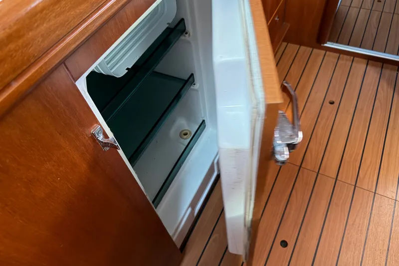 Slide: The Image of Open refrigerator on 2001 Beneteau 50 yacht with wooden flooring. - 16
