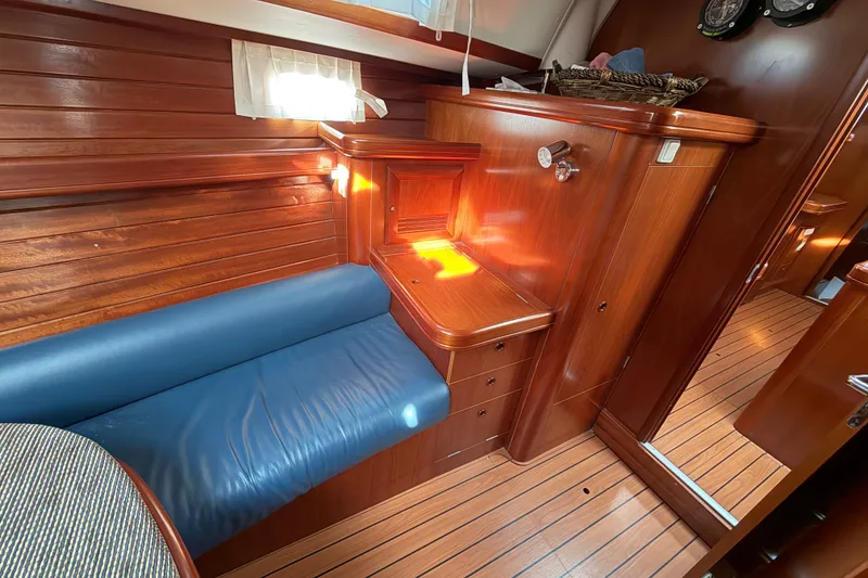 Slide: The Image of Luxurious wooden interior of a 2001 Beneteau 50 yacht with blue seating. - 6