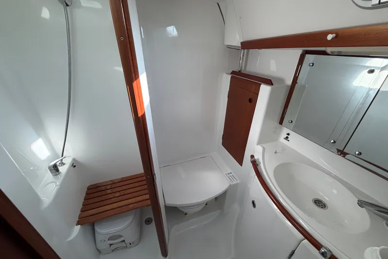 Slide: The Image of Bathroom interior of a 2001 Beneteau 50 yacht, featuring a shower, toilet, and sink. - 17