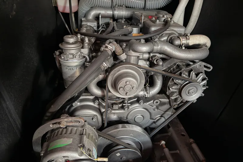 Slide: The Image of Engine of a 2001 Beneteau 50 sailboat, showcasing intricate mechanical components. - 19