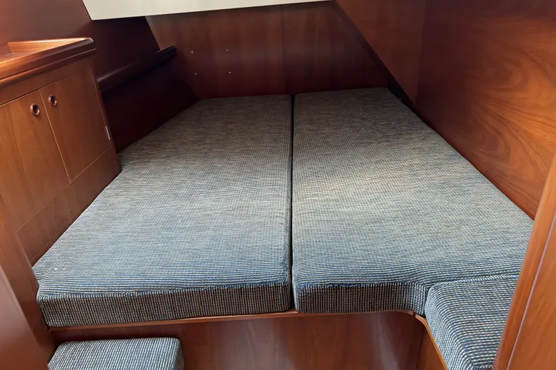 Slide: The Image of Cozy cabin interior of 2001 Beneteau 50 yacht with twin beds and wooden finish. - 14
