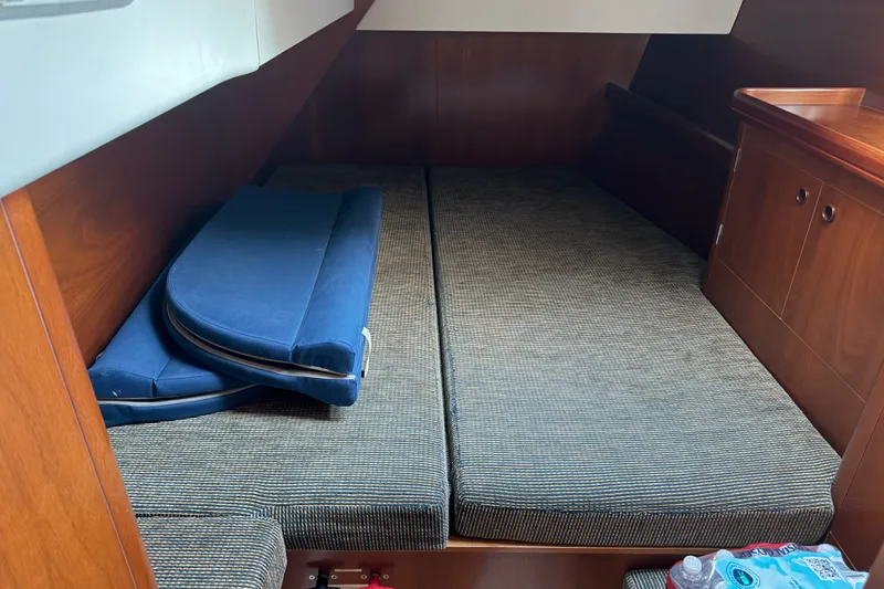 Slide: The Image of Interior cabin of a 2001 Beneteau 50 yacht with cushions and wooden cabinetry. - 13