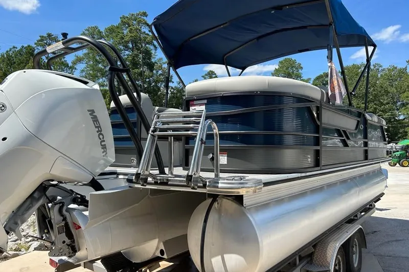 Slide: The Image of 2019 Crest Classic 230 SLC pontoon boat with Mercury engine and blue canopy. - 5