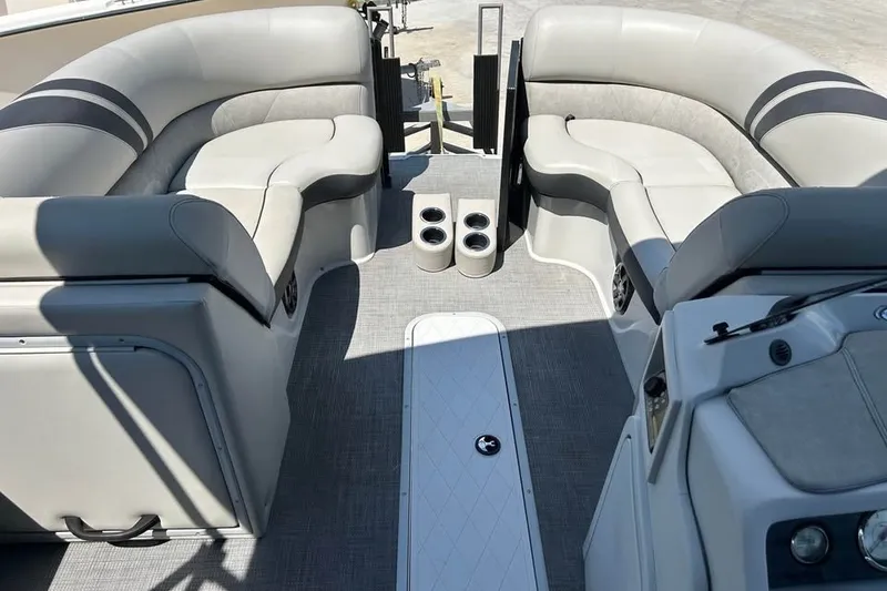 Slide: The Image of 2019 Crest Classic 230 SLC boat interior with plush seating and cup holders. - 8