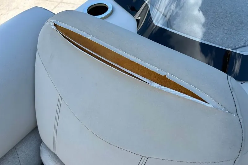 Slide: The Image of Torn upholstery on 2019 Crest Classic 230 SLC boat seat, revealing interior material. - 3