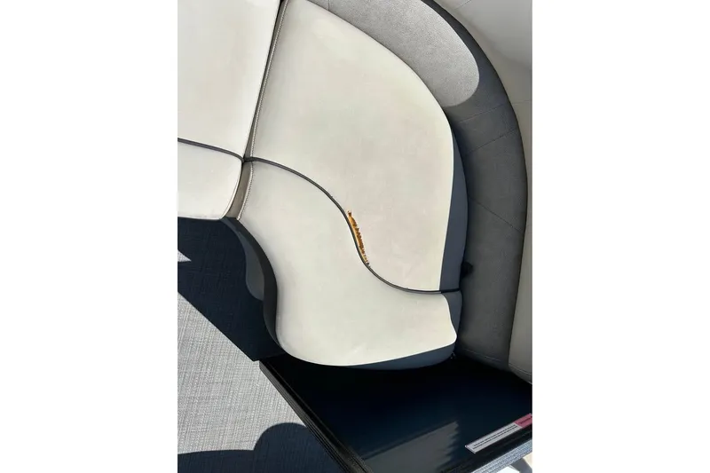 Slide: The Image of Crest Classic 230 SLC 2019 boat seating with light upholstery and dark accents. - 9
