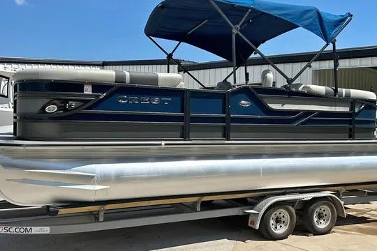 The Image of 2019 Crest Classic 230 SLC pontoon boat with blue canopy on trailer. - 1