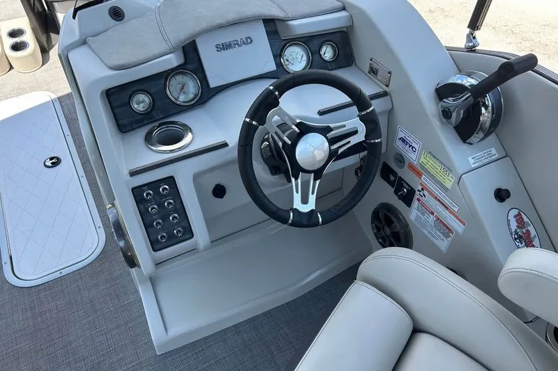 Slide: The Image of Steering console of 2019 Crest Classic 230 SLC boat with Simrad display and controls. - 7