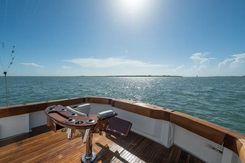 Slide: The Image of 2005 Hatteras 60 Convertible yacht deck with ocean view under clear blue sky. - 41