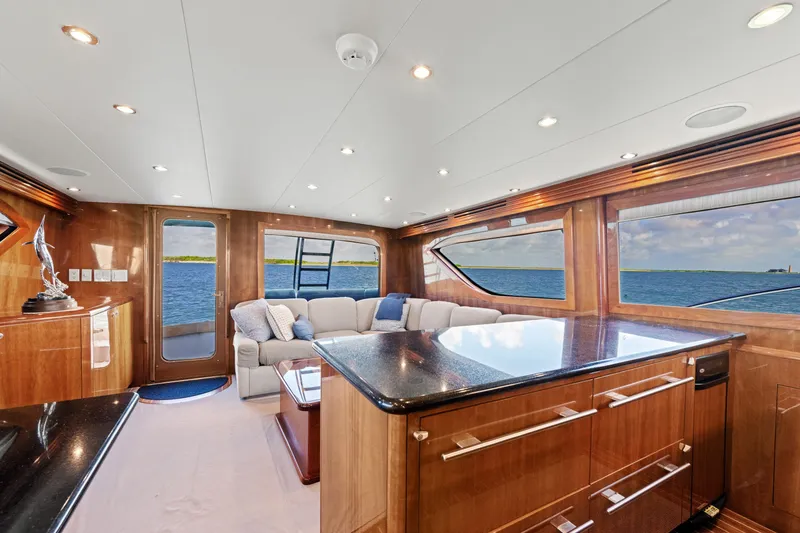 Slide: The Image of Luxurious interior of 2005 Hatteras 60 Convertible yacht with ocean view and elegant furnishings. - 12