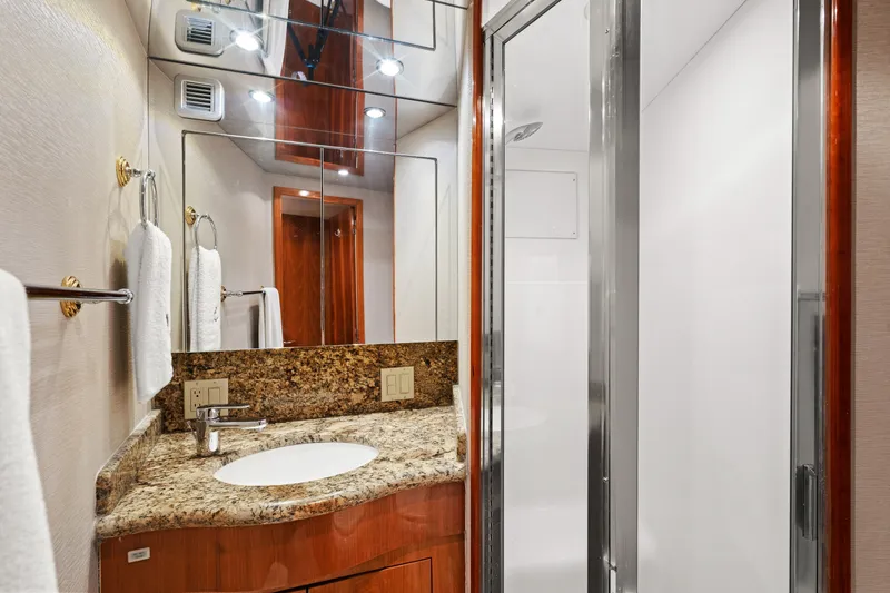 Slide: The Image of Luxurious bathroom in 2005 Hatteras 60 Convertible yacht with granite countertop and modern fixtures. - 24