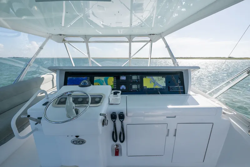 Slide: The Image of Helm of 2005 Hatteras 60 Convertible yacht with navigation screens and ocean view. - 29