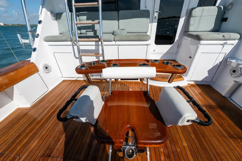 Slide: The Image of Luxurious 2005 Hatteras 60 Convertible yacht deck with teak flooring and fishing chair. - 44