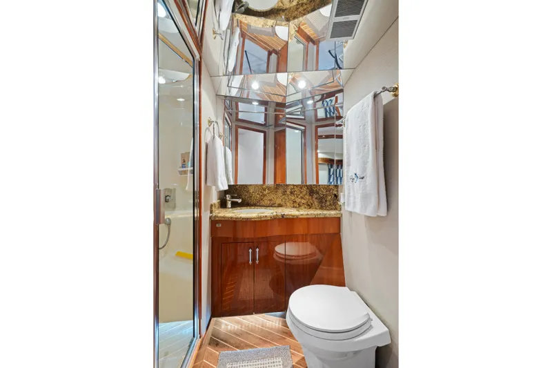 Slide: The Image of Luxurious bathroom in 2005 Hatteras 60 Convertible yacht with granite countertop and elegant wood cabinetry. - 20