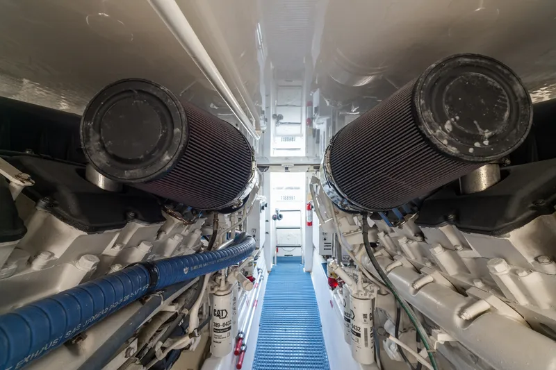 Slide: The Image of Engine room of 2005 Hatteras 60 Convertible yacht, showcasing dual engines and components. - 53