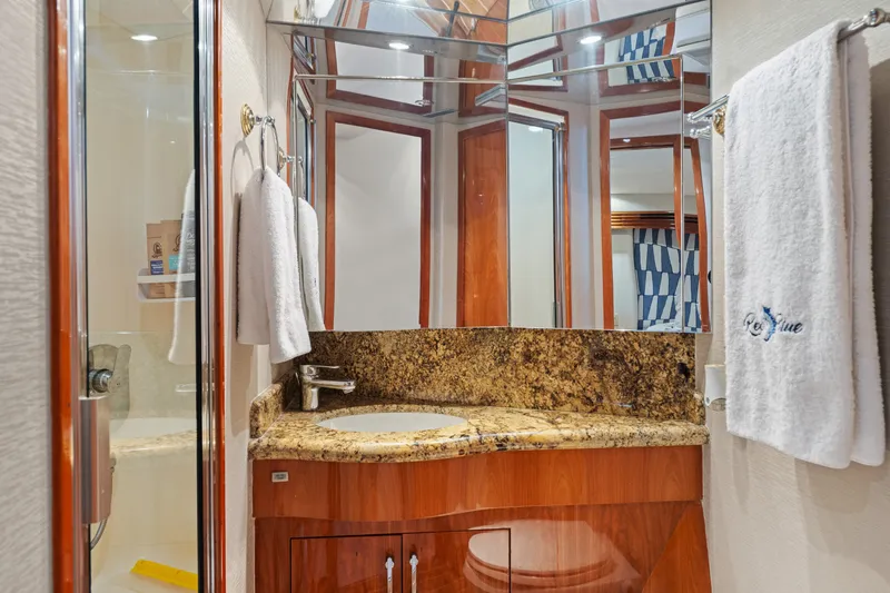 Slide: The Image of Luxurious bathroom in 2005 Hatteras 60 Convertible yacht with granite countertop and mirrored cabinets. - 21