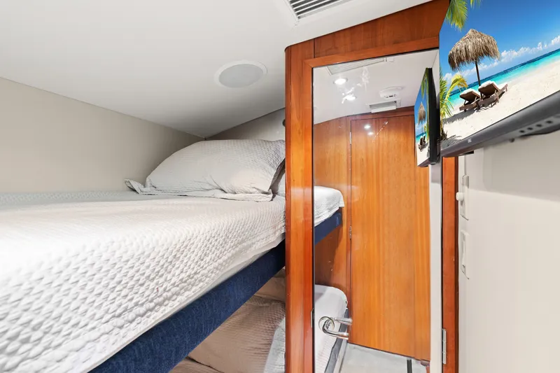 Slide: The Image of Interior of 2005 Hatteras 60 Convertible yacht with bunk beds and wooden door. - 18