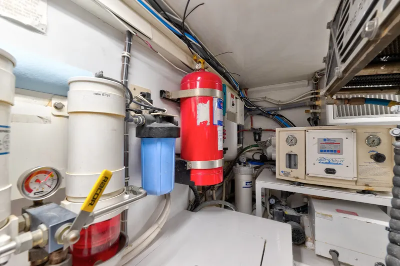 Slide: The Image of Engine room of 2005 Hatteras 60 Convertible yacht with fire extinguisher and filtration system. - 52