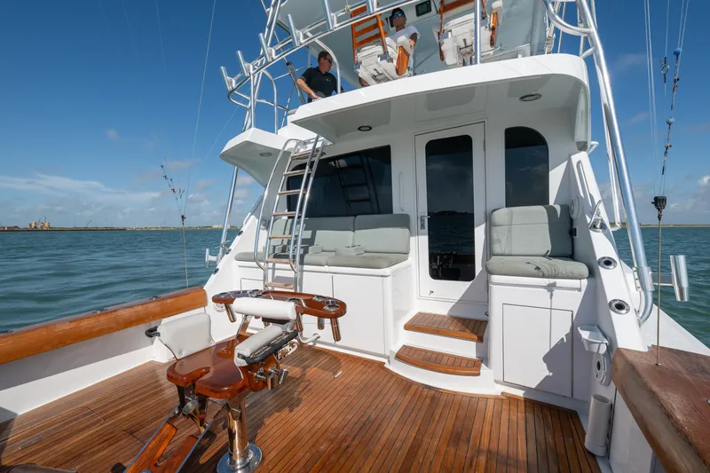 Slide: The Image of 2005 Hatteras 60 Convertible yacht with teak deck and fishing chair on open water. - 39