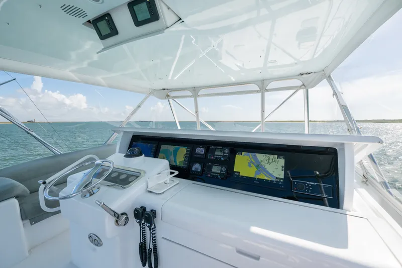 Slide: The Image of Helm of 2005 Hatteras 60 Convertible yacht with navigation screens and steering wheel. - 30