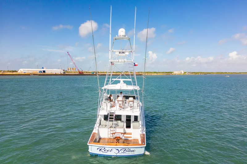 Slide: The Image of 2005 Hatteras 60 Convertible yacht on open water, clear sky, rear view. - 2