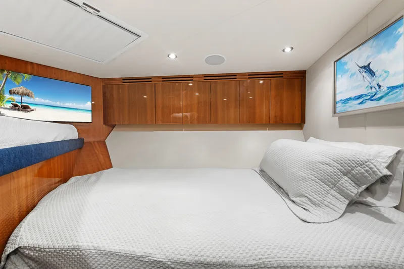 Slide: The Image of Luxurious cabin interior of 2005 Hatteras 60 Convertible yacht with cozy bedding and elegant wood finishes. - 23