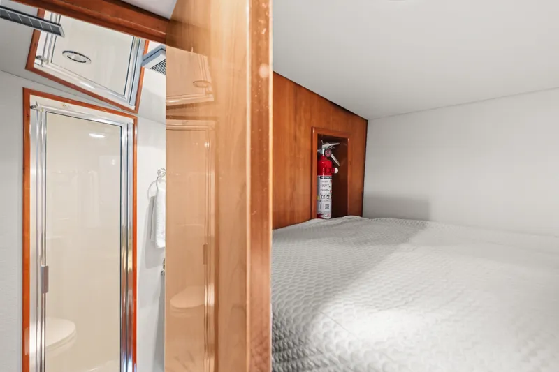Slide: The Image of Interior of 2005 Hatteras 60 Convertible yacht with bed and fire extinguisher. - 19