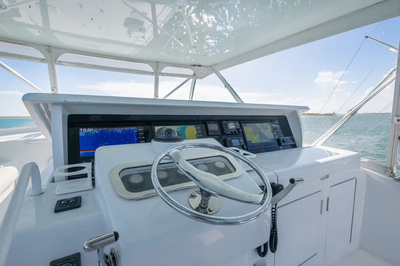 Slide: The Image of Helm of 2005 Hatteras 60 Convertible yacht with navigation equipment and ocean view. - 28