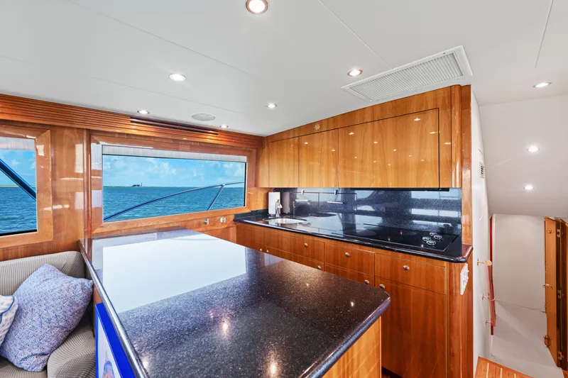 Slide: The Image of Luxurious 2005 Hatteras 60 Convertible yacht interior with sleek kitchen and ocean view. - 9