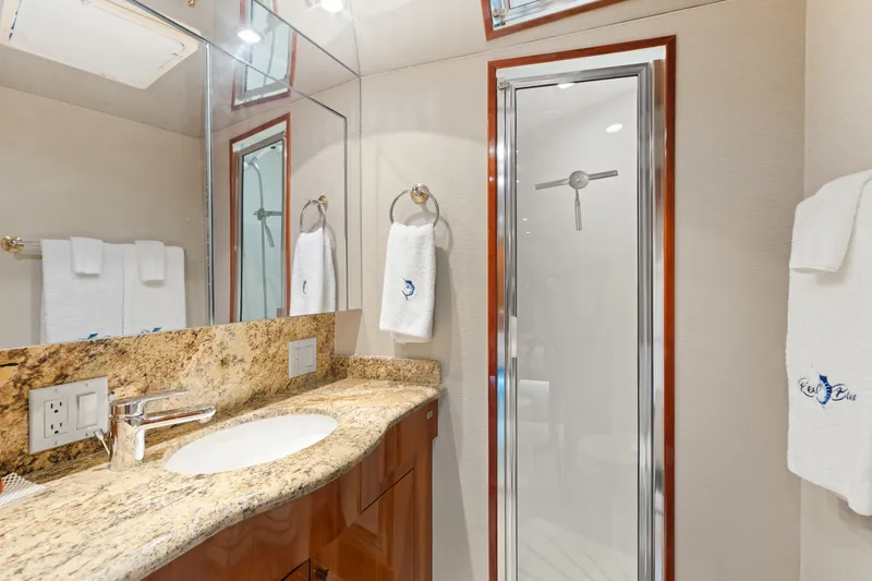 Slide: The Image of Luxurious bathroom in 2005 Hatteras 60 Convertible yacht with granite countertop and glass shower. - 16