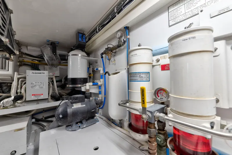 Slide: The Image of Engine room of 2005 Hatteras 60 Convertible yacht with filtration systems and machinery. - 51