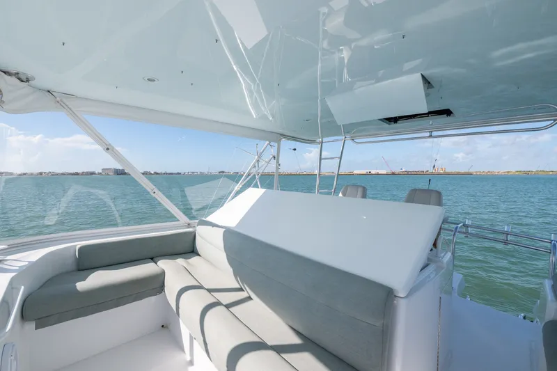 Slide: The Image of Luxurious seating area on a 2005 Hatteras 60 Convertible yacht with ocean view. - 34