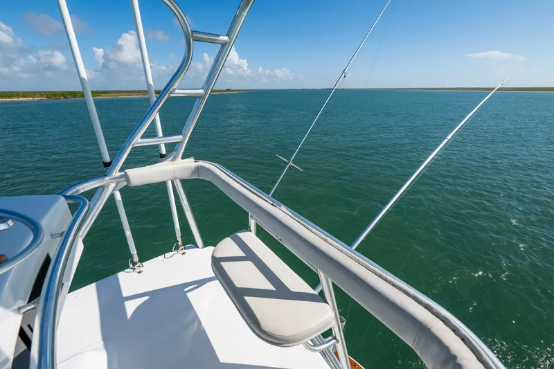 Slide: The Image of Fishing deck view on 2005 Hatteras 60 Convertible yacht, overlooking calm blue waters. - 37