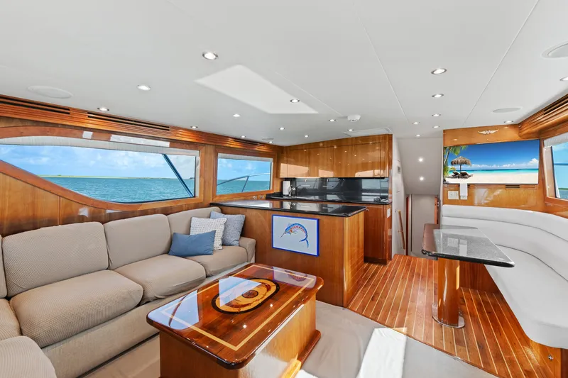Slide: The Image of Luxurious interior of 2005 Hatteras 60 Convertible yacht with elegant wood finishes and ocean views. - 4