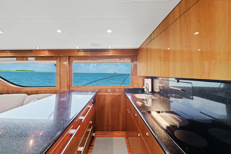 Slide: The Image of Luxurious kitchen interior of 2005 Hatteras 60 Convertible yacht with ocean view. - 10