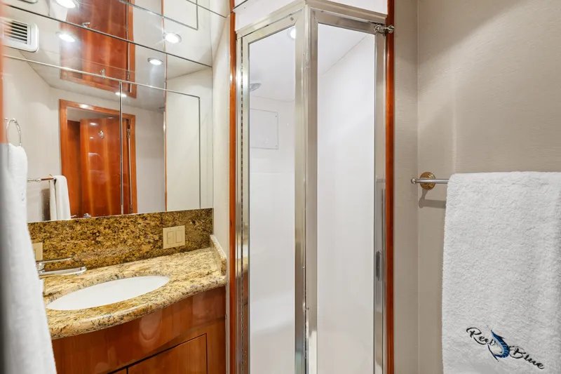 Slide: The Image of Luxurious bathroom in 2005 Hatteras 60 Convertible yacht with granite countertop and shower. - 25