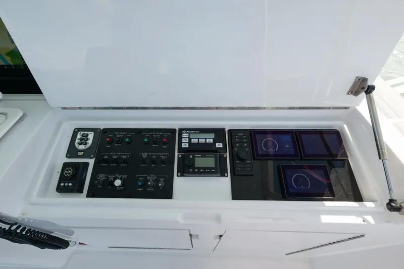Slide: The Image of Control panel of a 2005 Hatteras 60 Convertible yacht with various instruments and displays. - 31