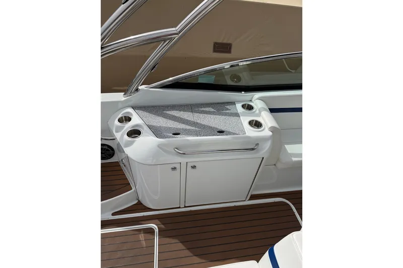 Slide: The Image of 2008 Formula 310 Bowrider boat interior with cup holders and storage cabinet. - 6