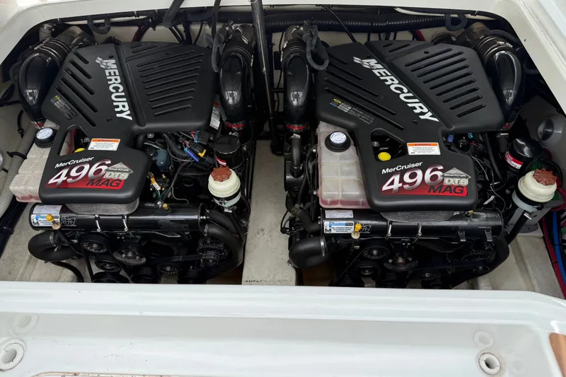 Slide: The Image of Two powerful MerCruiser 496 MAG engines in a boat's engine compartment, clean and well-maintained. - 14