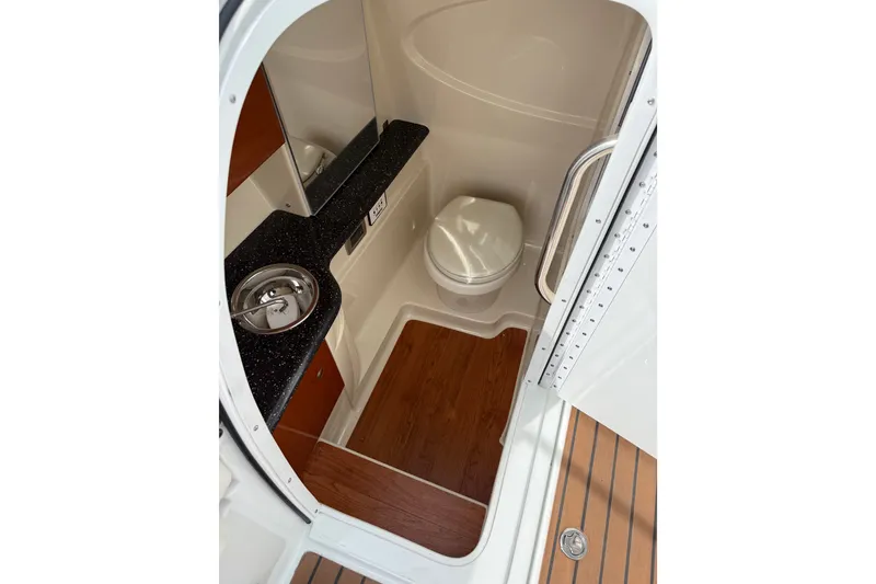 Slide: The Image of 2008 Formula 310 Bowrider bathroom with sink, toilet, and wood flooring. - 10