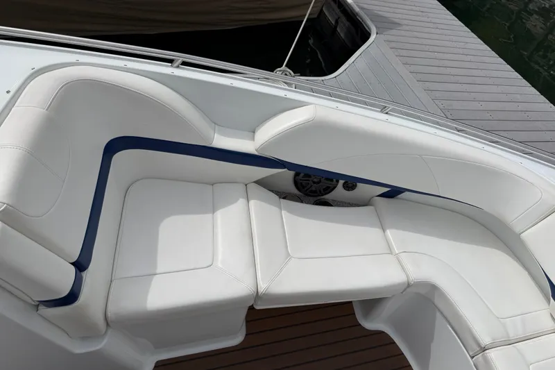 Slide: The Image of 2008 Formula 310 Bowrider boat with white cushioned seating and blue accents. - 13