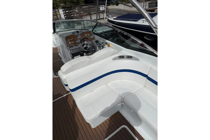 Slide: The Image of 2008 Formula 310 Bowrider interior with white seating and wood-accented dashboard. - 7