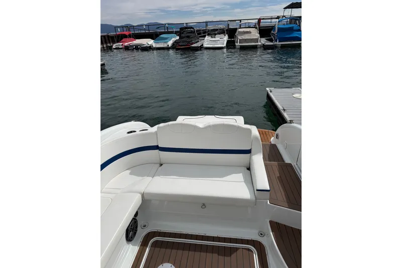 Slide: The Image of 2008 Formula 310 Bowrider boat with white seating, docked at a marina. - 5
