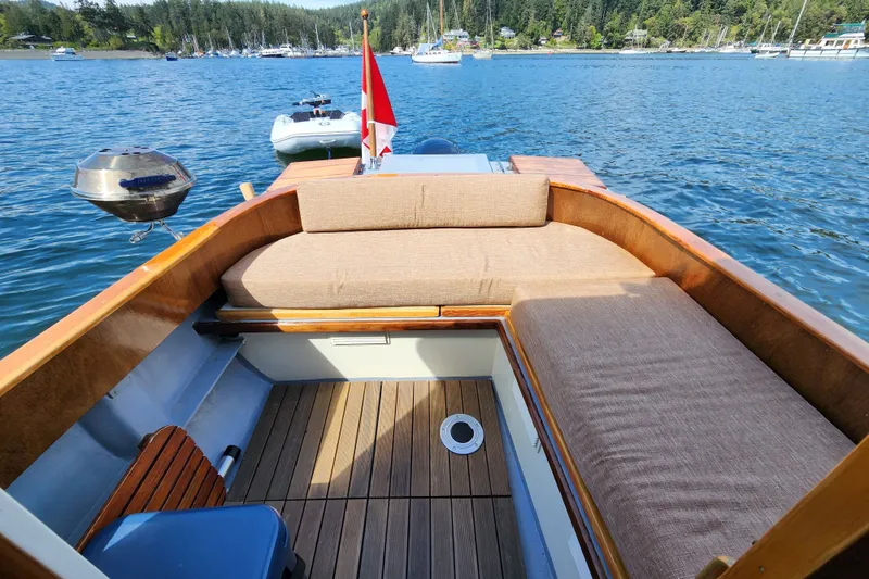 Slide: The Image of Cozy seating area on a 1974 custom launch boat with scenic lake view. - 5