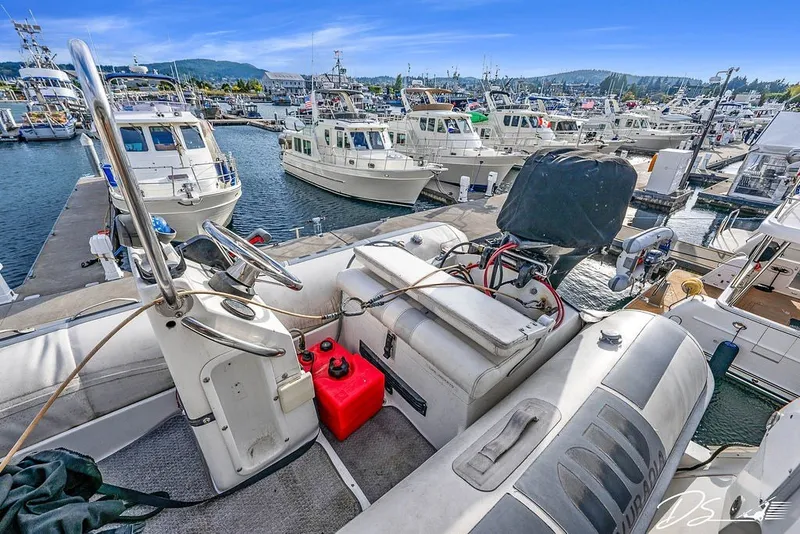 Slide: The Image of 1993 Tollycraft 57 Pilothouse Motor Yacht docked at a marina with other boats. - 30