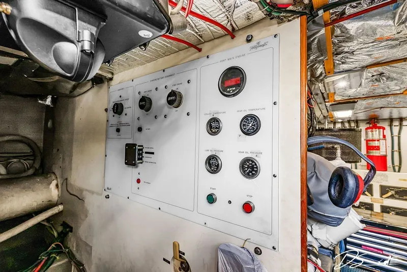 Slide: The Image of Engine control panel of a 1993 Tollycraft 57 Pilothouse Motor Yacht, featuring gauges and switches. - 42
