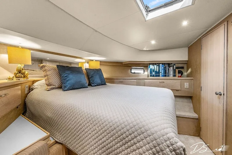 Slide: The Image of Luxurious bedroom interior of 1993 Tollycraft 57 Pilothouse Motor Yacht with skylight and cozy bedding. - 16