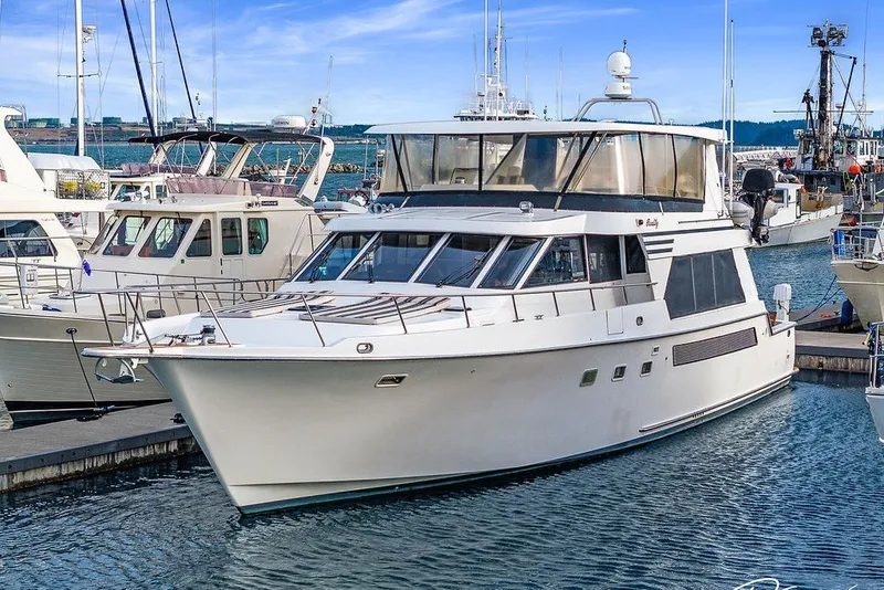 Slide: The Image of 1993 Tollycraft 57 Pilothouse Motor Yacht docked at marina, surrounded by other boats. - 46