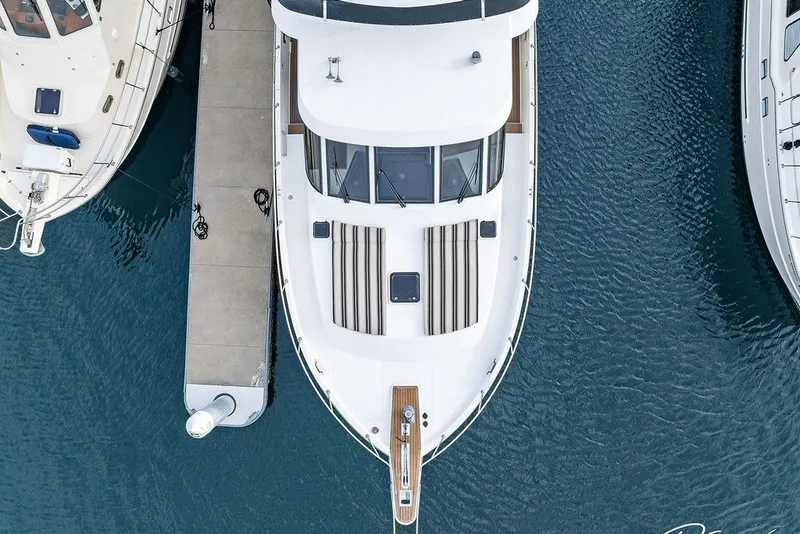 Slide: The Image of Aerial view of 1993 Tollycraft 57 Pilothouse Motor Yacht docked at marina. - 48