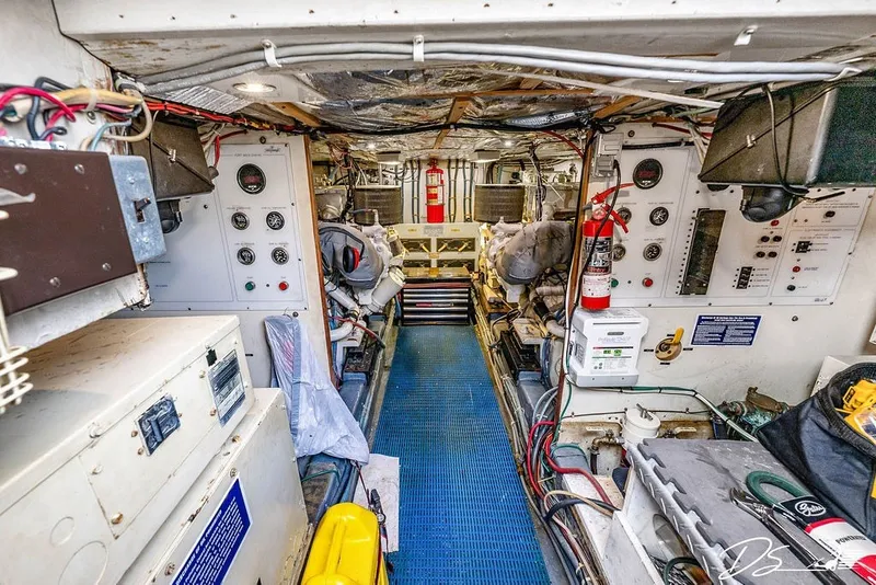 Slide: The Image of Engine room of a 1993 Tollycraft 57 Pilothouse Motor Yacht, featuring control panels and equipment. - 37